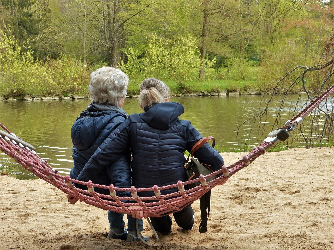 Two women sitting on a hammock